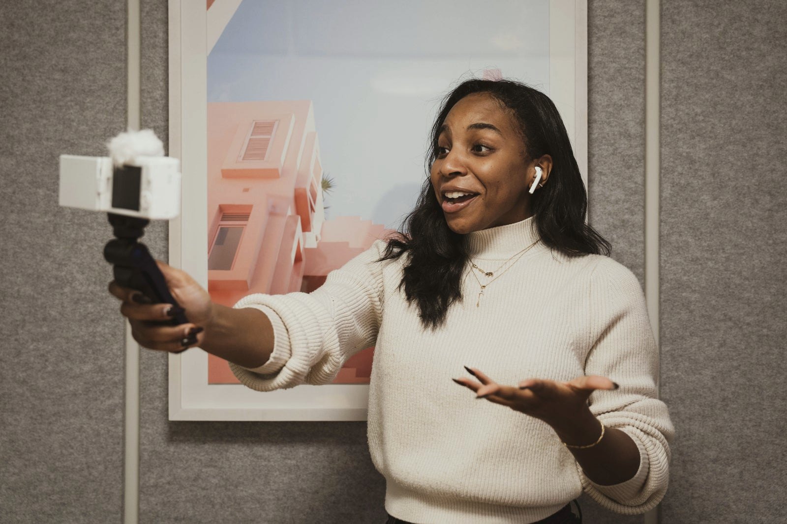 A creator recording a video on a phone gimbal, talking to her audience